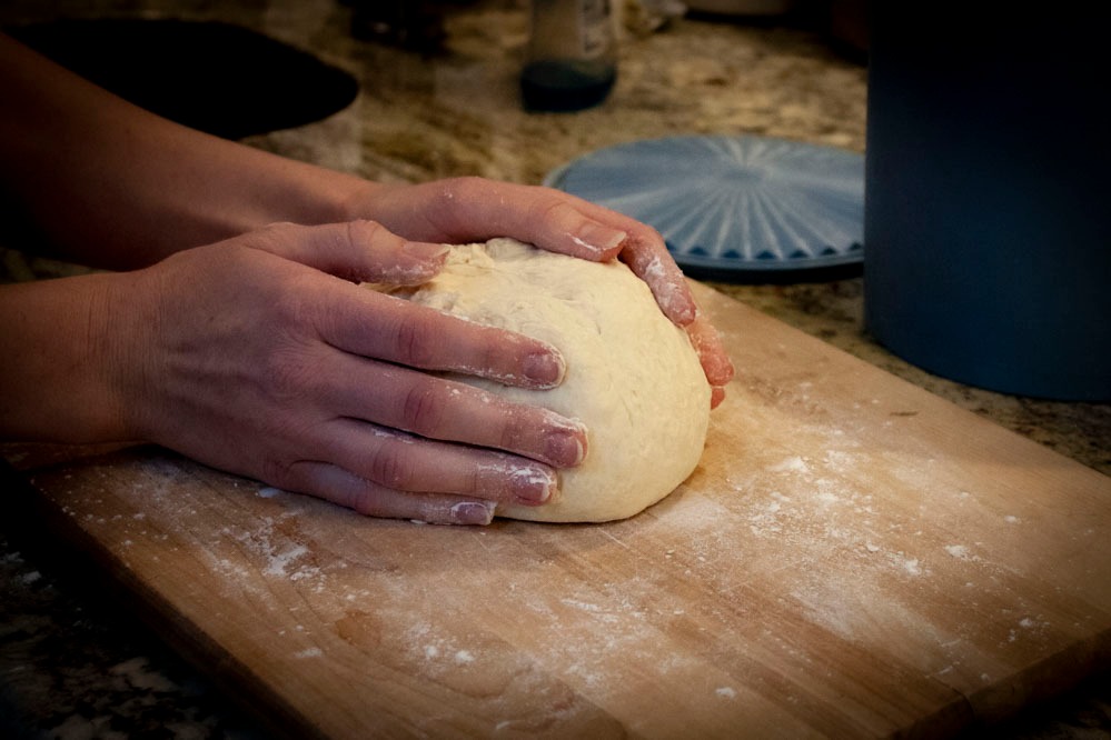 Flip the dough over and tap into a round loaf